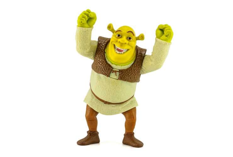 A green ogre named Shrek holding his hands above his head