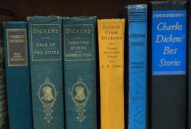 six Charles Dickens books in green, blue and yellow